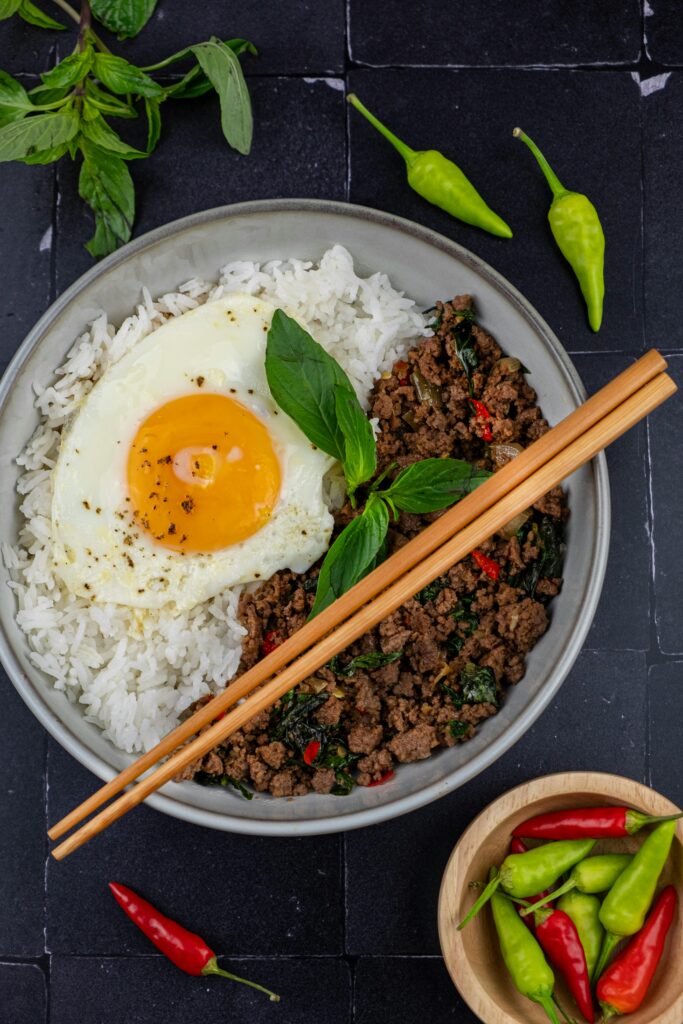 Delicious Thai basil beef served with a perfectly fried egg over fluffy rice.